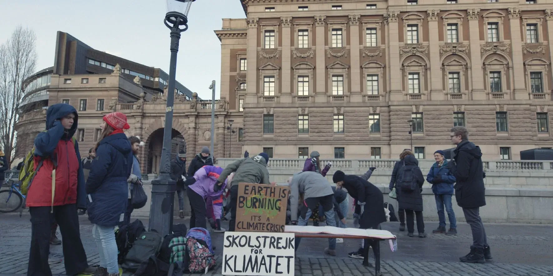 School climate strike outside the Swedish parliament, with hand-painted placards reading Skolstrejk för klimatet